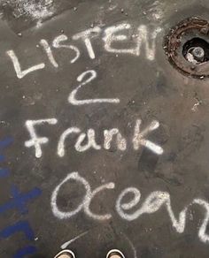 someone's feet are standing in front of a drain with the words listen to frank ocean written on it