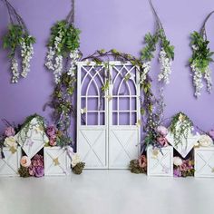 an arrangement of flowers and greenery decorates the walls of a purple walled room