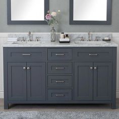 a bathroom with two sinks and mirrors on the wall next to each other in gray