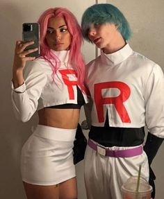 two people dressed in costumes taking a selfie