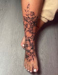 a woman's foot with flowers on it