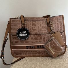 Steve Madden Bpierce Logo Handbag With Interior Crossbody Pouch And Keychain Id Wallet (New) Brand: Steve Madden Color: Tan Condition: New With Tags; Never Used Measurements: Length Across: 15 Inches Height: 10 3/4 Inches Width: 5 1/2 Inches Strap Drop: 11 1/2 Inches Detachable Belted Strap Is Adjustable Cross Body Strap Is Belted, Removable And Adjustable From 44 Inches To 48 1/2 Inches All Over Steve Madden Logo Handbag. Interior Logo Pouch That Can Be Used As A Crossbody Bag With The Removal Steve Madden Cross Body Bag, Steve Madden Burgent Bag, Steve Madden Bag Outfit, Interior Logo, Id Wallet, Steve Madden Bags, Bags Logo, Womens Tote Bags, Steve Madden