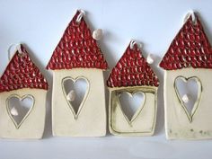 three red and white houses with hearts on them