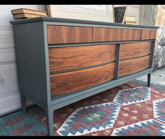 a large wooden dresser sitting on top of a carpeted floor next to a wall