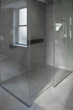 an empty bathroom with a glass shower stall