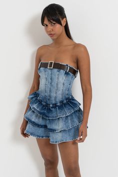 In stock and ready to ship in 2-3 business days. Made in Europe and available for a limited time only! This strapless belted denim mini dress features cascading tiers of ruffles for a playful chic look. Flaunt your fashion-forward flair with this must-have addition to your wardrobe! Color may vary due to lighting Model is wearing size S Material: cotton Care: machine wash cold Strapless Denim Dress, Jean Outfit, Wardrobe Color, Chic Look, Denim Mini Dress, Plaid Skirt, Mixing Fabrics, Skirt Dress, Denim Mini