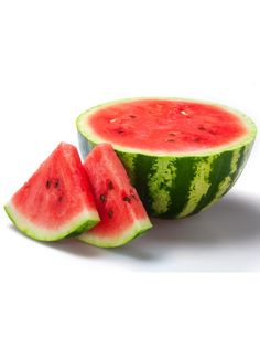 watermelon sliced in half and sitting on a white surface with one slice missing