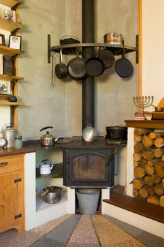 an old fashioned stove with pots and pans on it's burners in a kitchen