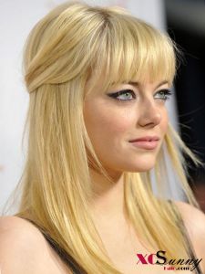 a woman with long blonde hair wearing a black dress and looking off to the side