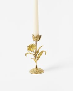 a candle that has some flowers in it