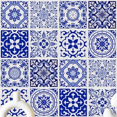 blue and white tiles with different designs on them