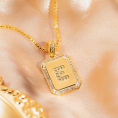 The overall golden color with full diamond edges can show a luxurious style. The letters are also meticulously inlaid with many gems, exquisite and sparkling. It can refract the dazzling light in the sun or under the light. Elegant Gold Iced Out Necklace, Gold Diamond Necklace With Rectangular Shape, Gold Diamond Rectangular Necklace, Octagon Shaped Gold Diamond Jewelry, Gold Necklace With Diamond And Rhinestones, Gold Diamond Necklace With Rhinestones, Personalized Gold Crystal Necklace, Elegant Gold Iced Out Necklaces, Gold Octagon Jewelry With Diamond Accents