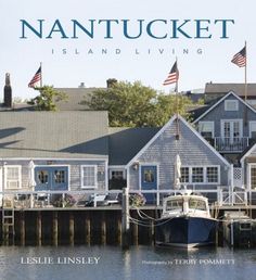 the cover of nantucket island living magazine, featuring boats docked in front of houses