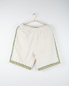 Our hand embroidered design was inspired by the beauty of traditional wall art and uses a special art form called Chikankari. Our Chikankar artisans live in Lucknow, where this technique is a specialty of that region. It takes a Chikankar a decade to learn and train. Featured on our Dipak shorts which have a regular rise, drawstring elastic waist. Relaxed fitting and utilitarian in nature, they are complete with special elements including a handmade drawcord, reinforced back pocket detail and fi White Cotton Embroidered Fabric For Festivals, White Cotton Traditional Wear With Embroidered Border, Off White Cotton Traditional Wear With Floral Embroidery, White Traditional Wear With Woven Motifs For Ceremonies, Festival White Embroidered Cotton Fabric, Ceremonial White Traditional Wear With Woven Motifs, Cream Cotton Traditional Wear With Embroidered Border, Cotton Folk Traditional Wear For Ceremonies, Folk Style Cotton Traditional Wear For Ceremonies