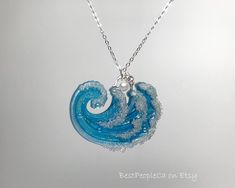 Immerse yourself in the serenity of the ocean with this captivating necklace, featuring a stunning blend of blue and green hues that mimic the gentle waves of the sea.  Crafted with meticulous attention to detail, this necklace is a perfect accessory for ocean lovers and those who wish to carry a piece of the sea's tranquility wherever they go.  Pendant Dimensions: 1 3/4 W * 1.5 H * 1/4 D inches                          44 W * 38 H * 10 D mm Pendant Weight: 5.8 gr This piece is graceful and exotic. The accessory is ready to ship. Thank you for your interest in my work. Alexandra. Light Blue Ocean-inspired Jewelry For Gift, Light Blue Ocean-inspired Jewelry Gift, Ocean-inspired Light Blue Jewelry For Gift, Ocean-inspired Blue Pendant Jewelry, Ocean-inspired Pendant Necklace, Ocean-inspired Turquoise Pendant Necklace, Ocean-inspired Blue Pendant Necklace, Handmade Ocean-inspired Blue Necklaces, Handmade Ocean-inspired Ocean Color Necklaces