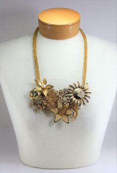 "Vintage Gold Flowers Pearls Rhinestone Metal Assemblage Statement Bib Necklace Handcrafted OOAK. Year around there are always weddings and parties to attend. So I got busy making this wonderful handcrafted necklace blooming with reclaimed vintage gold metal flower pins and other vintage pieces, including pearls and rhinestones, to make this eye catching statement necklace. Vintage gold tone link necklace doubled for added flair! Total drop of necklace is 13\" to bottom of flowers at longest len Gold Crystal Bridal Necklace For Celebrations, Gold Embellished Evening Necklaces, Gold Embellished Evening Necklace, Glamorous Gold Bridal Necklace For Party, Gold Embellished Wedding Jewelry, Glamorous Embellished Gold Jewelry, Glamorous Gold Embellished Jewelry, Gold Jeweled Bridal Necklace For Party, Gold Necklaces With Sparkling Stones For Wedding