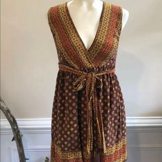 Brand New With Tags! Never Been Worn! Brown And Mustard Anna Sui For Target Wrap Mini Dress With Sleeveless, Surplice Neckline, Sash Tie At Waist, And Snap Closure At Front Waist. Fabric: Shell - 100% Silk, Lining - 100% Polyester Measurements: Waist 24”, Pit To Pit 15”, Length 33” Boho Print Sleeveless Sundress, Yellow Bohemian Sleeveless Dress For Beach, Fitted Bohemian Maxi Dress With Tie Waist, Sleeveless Summer Midi Dress With Boho Print, Yellow Tie Waist Beach Dress, Sleeveless Sundress With Tie Waist, Bohemian Sleeveless Brown Dress For Beach, Casual Yellow Boho Print Dress, Bohemian Sleeveless Dress With Tie Waist