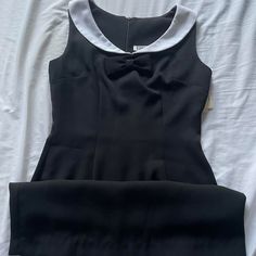 Vintage 90s Does 60s Mod Deadstock Black Tank Dress With Collar. White Collar With Bow Detailing Underneath. Zipper At Back. Original Tags Still Attached. Measurements Taken Lying Flat And Doubled. Bust: 32" Waist: 26" Hips: 34" Total Length: 30 ½" #Goth #90s #Deadstock #Vintage 90's Does 60's, Retro Black Knee-length Mini Dress, Black Retro Knee-length Mini Dress, Retro Knee-length Mini Dress For Formal Occasions, Fitted Retro Black Mini Dress, 60s Dresses Vintage, 60s Goth, 1960s Dresses Vintage, 1960s Fashion Women