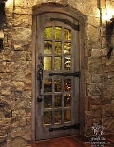 a stone wall with a wooden door and glass inserts