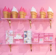 an ice cream shop with pink walls and shelves filled with different flavors of ice cream