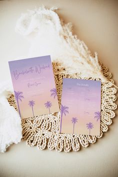 wedding stationery with palm trees on the front and back, sitting on a crocheted doily