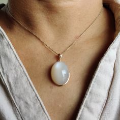 ITEM DESCRIPTION: >>The pendant is made from Solid 14K Yellow Gold. Gemstone used is absolutely natural and ethically sourced. >>Natural White Moonstones cabochon cut and oval shape with bezel setting are studded on it with utmost precision. >>This is a minimalist design and is absolutely hassle-free and everyday jewelry. ✓ Gem: White Moonstone ✓ Gem size: 15x24 mm ✓ Gem weight: 29.04 carats ✓ Gold purity: 14K (58.33% approx.) ✓ Gold weight: 0.67 grams ✓ Gross weight: 6.48 grams The Gold purity Elegant White Necklace With Large Stone, Elegant White Necklaces With Large Stone, Elegant White Jewelry With Large Stone, Elegant Moonstone Oval Pendant Jewelry, White Oval Cabochon Gemstone Necklace, Elegant Moonstone Necklace With Large Stone, White Moonstone Necklace For Formal Occasions, Formal White Moonstone Necklace, White Moonstone