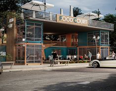 a car parked in front of a building with food court on it's roof