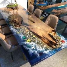 a dining table made out of wood and glass with shells on the bottom, surrounded by chairs