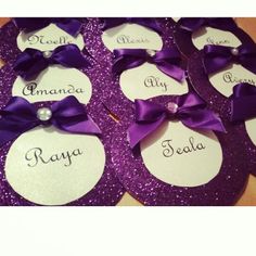 purple and white name tags with bows on them