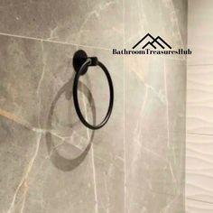 a bathroom with a black towel ring on the wall