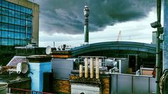 the sky is dark and cloudy over some buildings