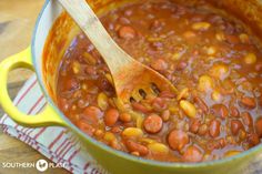 a pot filled with beans on top of a wooden table