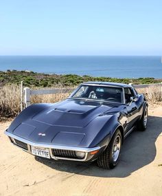 a car parked in front of the ocean