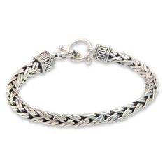 An intricate braid of sterling strands forms a delightful bracelet by Wayan Asmana. Exalting the gleam of silver he designs outstanding pieces based on the rich heritage of Bali's traditional culture. .925 Sterling silver