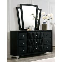 a black dresser and mirror in a room