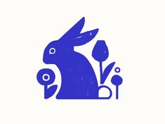 a blue rabbit sitting next to some flowers