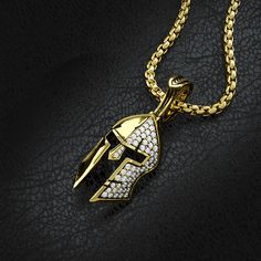 This solid gold and half paved diamond Spartan pendant is a symbol of Strength, Courage, Loyalty, and Power. The Yellow Gold Spartan Pendant was created for Free Men who demand the most of themselves and break the shackles of society. The inside of the helmet is beautifully sculpted with a Spartan shield and Spartan warriors bearing the swords. MATERIALS, WEIGHTS & MEASUREMENTS: Small Size: 14 karat gold weight is 11 grams and 18 karat gold weight is 13 grams. 55 VVS Colorless diamonds totaling Symbolic Diamond Accents Pendant Jewelry, Symbolic Pendant Jewelry With Diamond Accents, Gold Jewelry With Diamond Accents, Symbolic Diamond Pendant Jewelry, Gold Pendant Jewelry With Pave Setting, Gold Jewelry Pendant With Pave Setting, Luxury Diamond White Jewelry For Collectors, Yellow Gold Medallion Jewelry With Pave Setting, White Gold Pave Setting Medallion Jewelry