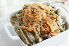 green bean casserole with onion rings in a white dish