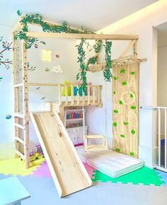 a child's play room with climbing wall and slide