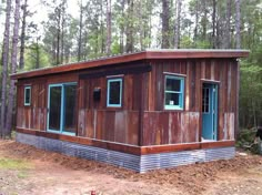 a small wooden building in the middle of a forest