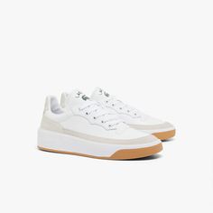 The G80 Club is a take on Lacoste’s original archive design. These classic court sneakers are crafted in leather upper with mesh ans synthetic lining and heel counter, offering a nod to Lacoste’s tennis DNA through a modern lens. Sports Sneakers With White Sole And Contrasting Heel Counter, Classic Sneakers With Contrasting Heel Counter For Sports, Classic Tennis Sneakers With Contrast Sole, Classic Tennis Sneakers With Round Toe, Tennis Sneakers With Gum Sole And Round Toe, Classic White Tennis Sneakers, Classic Tennis Sneakers With Gum Sole, Tennis Sneakers With Perforated Toe Box And White Sole, Tennis Sneakers With Rubber Sole And Round Toe