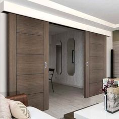 a living room with sliding doors leading to the bedroom