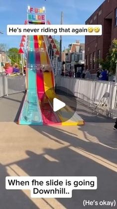 an upside down slide in the middle of a street with people walking by and texting it's never riding that again