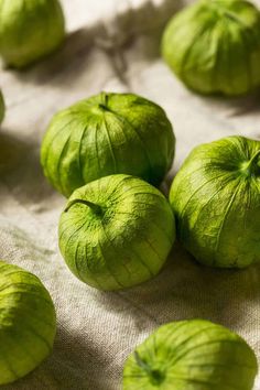 fresh green tomatoes on a linen tablecloth, ready to be cooked or put in the oven