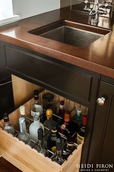 a kitchen sink sitting under a wooden counter top