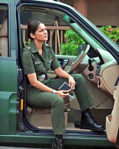 a woman in uniform sitting on the driver's seat of a vehicle