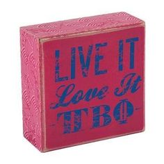 a wooden block with the words live it, love it, and tro written on it