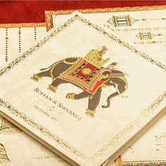 three napkins with an elephant on them sitting next to each other in front of a red background