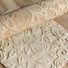 two rolling doughs sitting on top of a wooden table