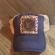 New denim worn look trucker hat with genuine Serape and Leopard Print leather patch and with authentic upcycled L V canvas sewn on it. We are not associated with any brand name. We only use 100% authentic items in our products that we upcycle into something handmade. Please message us for more information.. Thank you and Happy Shopping :) Kept this one for myself! It really fires up my western style! DISCLAIMER: WAITES MADE DOES NOT SELL LICENSED LOUIS VUITTON OR GUCCI PRODUCTS. ALL OF OUR CANVA Casual Trucker Hat With Leather Patch, Casual Baseball Cap With Leather Patch, Casual Brown Hat With Patches, Leopard Hat, Louis Vuitton Hat, Handbag Boutique, Western Handbags, Denim Wear, Boutique Accessories